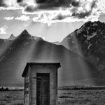 1301 Crepuscular rays ('God beams') on outhouse, Grand Teton National Park,WY